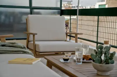 a living room with a chair and a coffee table at Fireside Kallithea - Large Veranda II - 3BR by ΜΡS in Athens