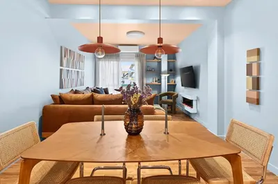 a dining room with a table and a couch at Fireside Kallithea - Large Veranda II - 3BR by ΜΡS in Athens