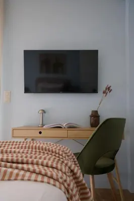 a bedroom with a bed and a television on a wall at Fireside Kallithea - Large Veranda II - 3BR by ΜΡS in Athens