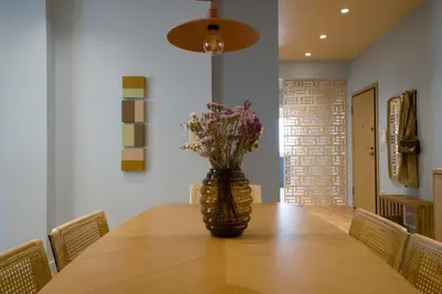 a vase of flowers sitting on top of a table at Fireside Kallithea - Large Veranda II - 3BR by ΜΡS in Athens
