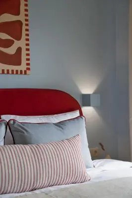 a bedroom with a bed with a red head board at Fireside Kallithea - Large Veranda I -2BR by ΜΡS in Athens