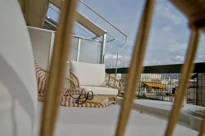 a balcony with a chair and a window at Fireside Kallithea - Large Veranda I -2BR by ΜΡS in Athens