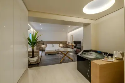 a living room with a bed and a living room with a room at Athensis Central Suites in Athens