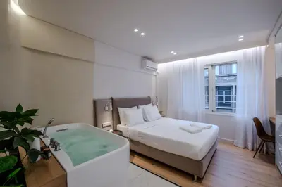 a bedroom with a bed and a bath tub at Athensis Central Suites in Athens