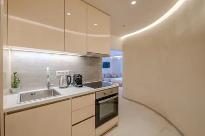 a kitchen with a sink and a stove at Athensis Central Suites in Athens