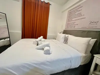 a white bed with towels on top of it at Carlo's Apartment in Athens
