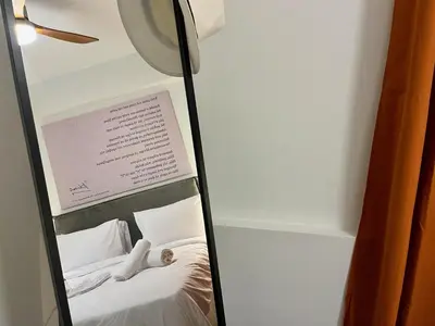 a mirror reflection of a bed in a room at Carlo's Apartment in Athens