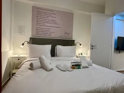 a white bed with towels on top of it at Carlo's Apartment in Athens