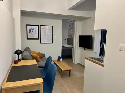 a living room with a couch and a table at Carlo's Apartment in Athens