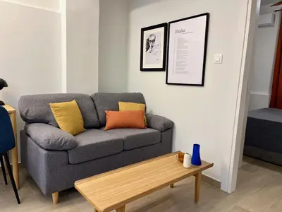 a living room with a couch and a coffee table at Carlo's Apartment in Athens