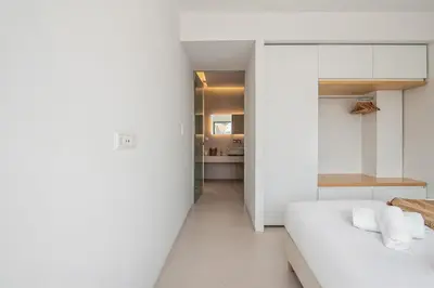 a bedroom with white walls and a white bed at An Interior in Its Purest Form in Athens