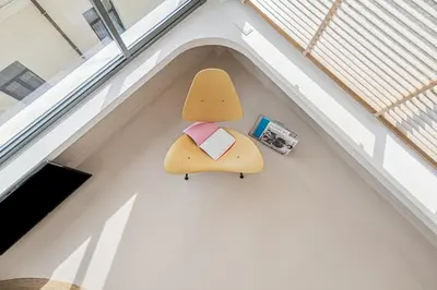 a stuffed animal with a book on a wall at An Interior in Its Purest Form in Athens