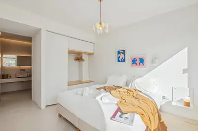 a white bedroom with a bed in a room at An Interior in Its Purest Form in Athens