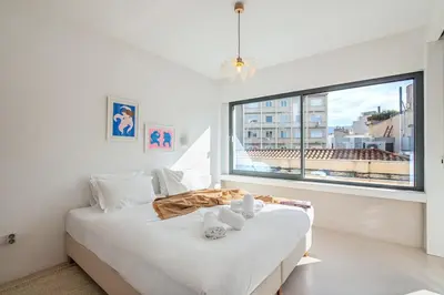 a bedroom with a white bed and a large window at An Interior in Its Purest Form in Athens