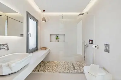 a white bathroom with a sink and a shower at An Interior in Its Purest Form in Athens