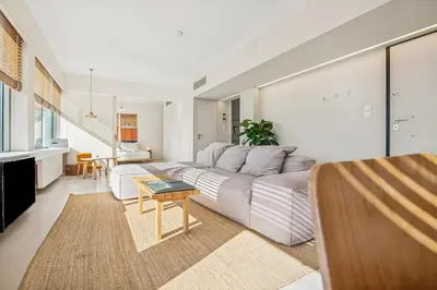 a living room with a couch and a table at Living Beyond Design in Athens