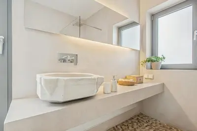 a bathroom with a large stone sink on a counter at Living Beyond Design in Athens