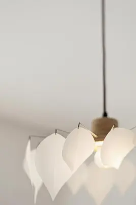 three white umbrellas hanging from a ceiling at Living Beyond Design in Athens