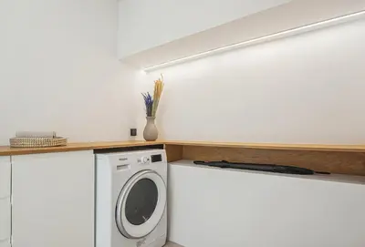 a laundry room with a washer and dryer at Living Beyond Design in Athens