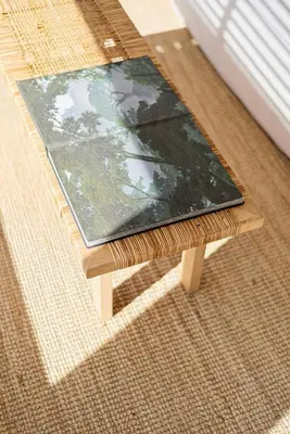 a book sitting on top of a wooden table at Living Beyond Design in Athens
