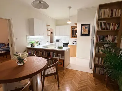 a kitchen and dining room with a table and a dining room gmaxwell gmaxwell at BLU apartment Piraeus Marina Zeas in Piraeus