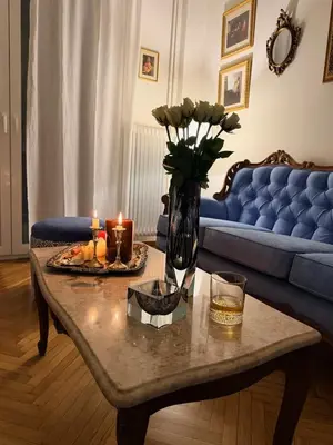 a living room with a table with candles and a couch at BLU apartment Piraeus Marina Zeas in Piraeus