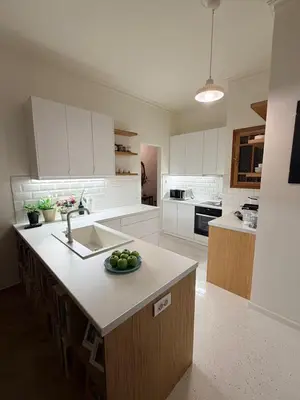 a kitchen with a sink and a bowl of fruit on a counter at BLU apartment Piraeus Marina Zeas in Piraeus