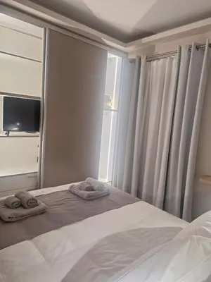 a bedroom with a bed with two towels on it at Sunshine houses one in Athens