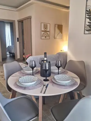 a table with plates and wine glasses on it at Sunshine houses one in Athens