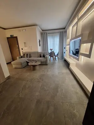 a living room with a couch and a flat screen tv at Sunshine houses one in Athens