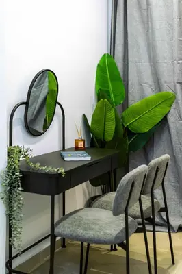 a black desk with two chairs and a mirror at Modern Studio l King Bed & Work Corner in Athens