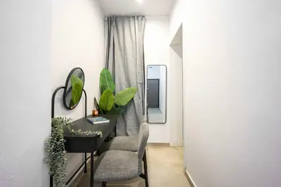 a room with a table and chairs and a mirror at Modern Studio l King Bed & Work Corner in Athens