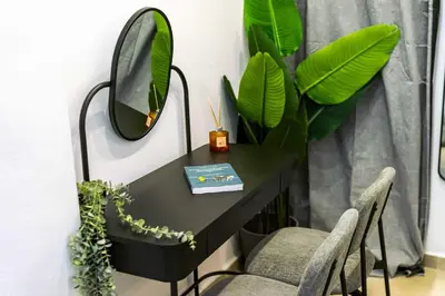 a black desk with a mirror and two chairs at Modern Studio l King Bed & Work Corner in Athens