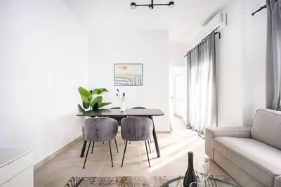 a living room with a table and a couch at Bright Cozy 2BR l Private Balcony & Work Corner in Athens