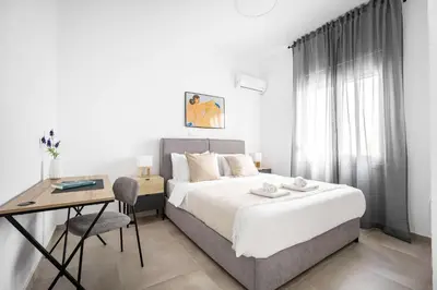 a bedroom with a bed and a desk and a table at Bright Cozy 2BR l Private Balcony & Work Corner in Athens