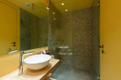 a bathroom with a sink and a shower at Alter Athens Downtown in Athens