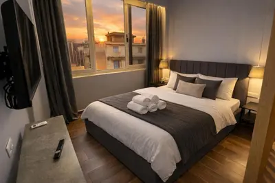 a bedroom with a bed with two towels on it at Piraeus Port Luxury Suites No3 in Piraeus