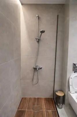 a bathroom with a shower with a toilet and a sink at Piraeus Port Luxury Suites No3 in Piraeus