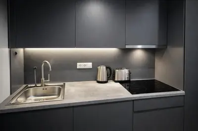 a kitchen with a sink and a stove at Piraeus Port Luxury Suites No3 in Piraeus