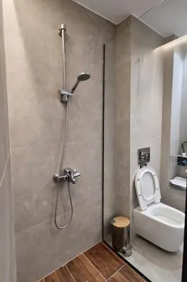 a bathroom with a shower and a toilet at Piraeus Port Luxury Suites No3 in Piraeus