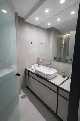a bathroom with a sink and a mirror at Piraeus Port Luxury Suites No3 in Piraeus