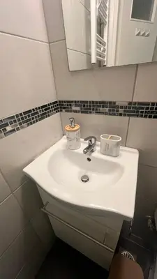 a bathroom with a white sink and a mirror at Sunny Homes Vournazou in Athens