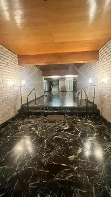 an empty room with a stone floor with lights at Sunny Homes Vournazou in Athens