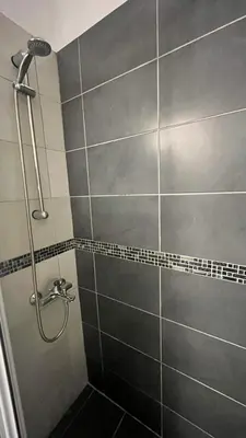 a bathroom with a shower with a glass door at Sunny Homes Vournazou in Athens