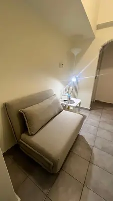 a small bed in a room with a table at Sunny Homes Vournazou in Athens