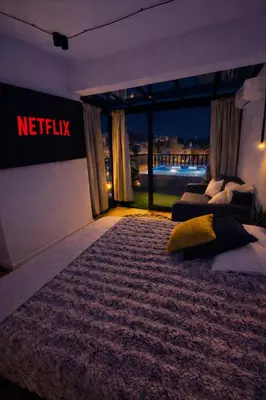a bedroom with a netflix sign on the wall at Athens Center Apartment with Private Jacuzzi in Athens