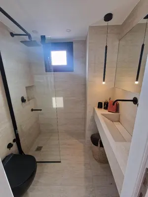 a bathroom with a shower with a glass door at Athens Center Apartment with Private Jacuzzi in Athens