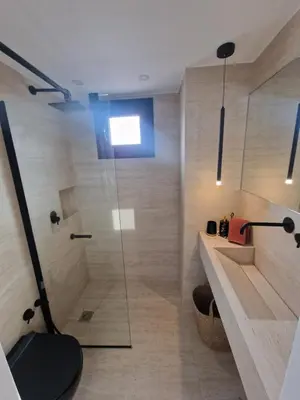 a bathroom with a shower with a glass door at Athens Center Apartment with Private Jacuzzi in Athens