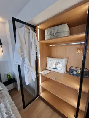 a closet with wooden shelves and a mirror at Athens Center Apartment with Private Jacuzzi in Athens