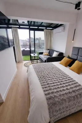 a bedroom with a large bed and a living room at Athens Center Apartment with Private Jacuzzi in Athens